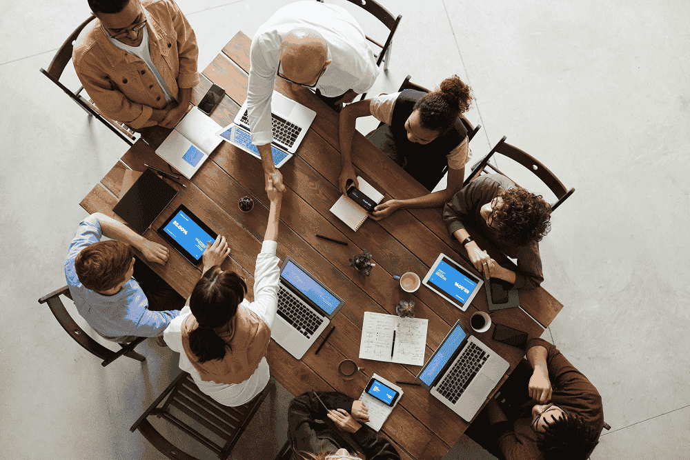 Photo of employees around a table, this is for the ethics section.